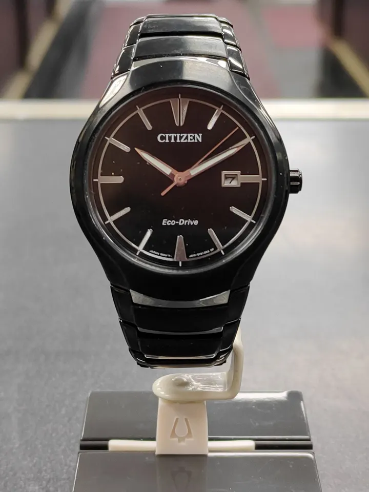Citizen Eco-Drive black ion-plated stainless steel watch with black dial and date shown from front, side, and ca