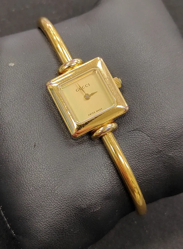 Gucci gold-plated Swiss quartz women's bangle watch with square champagne dial and sapphire crystal