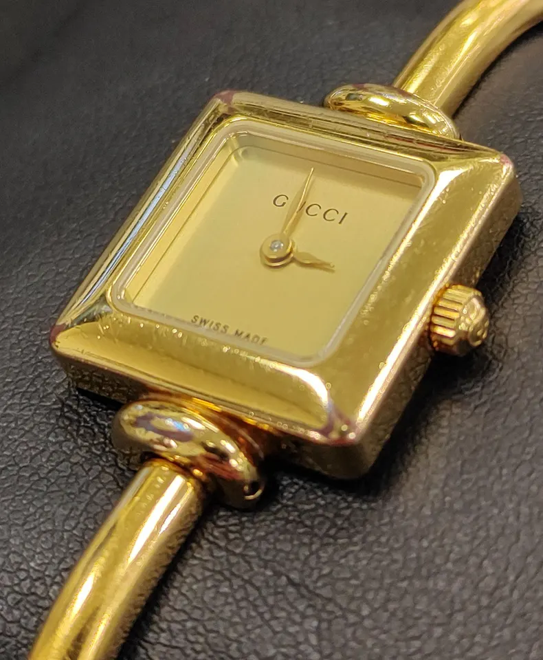 Gucci gold-plated Swiss quartz women's bangle watch with square champagne dial and sapphire crystal