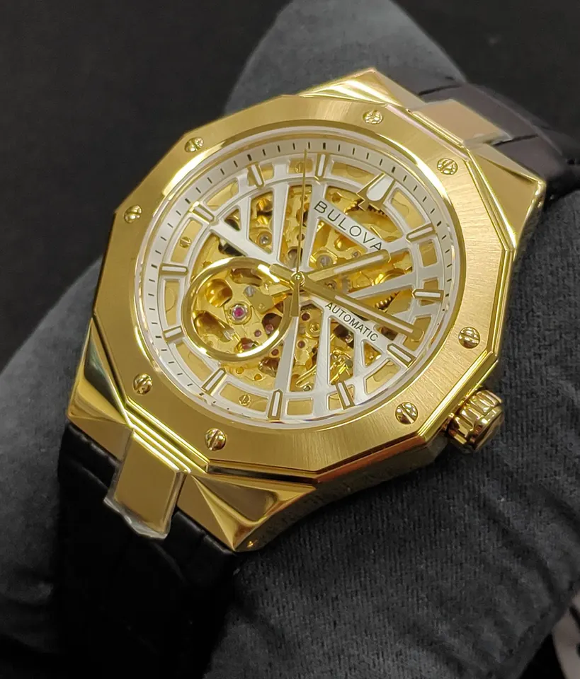 Brand new Bulova Maquina gold-tone automatic skeleton watch with black leather strap and original box