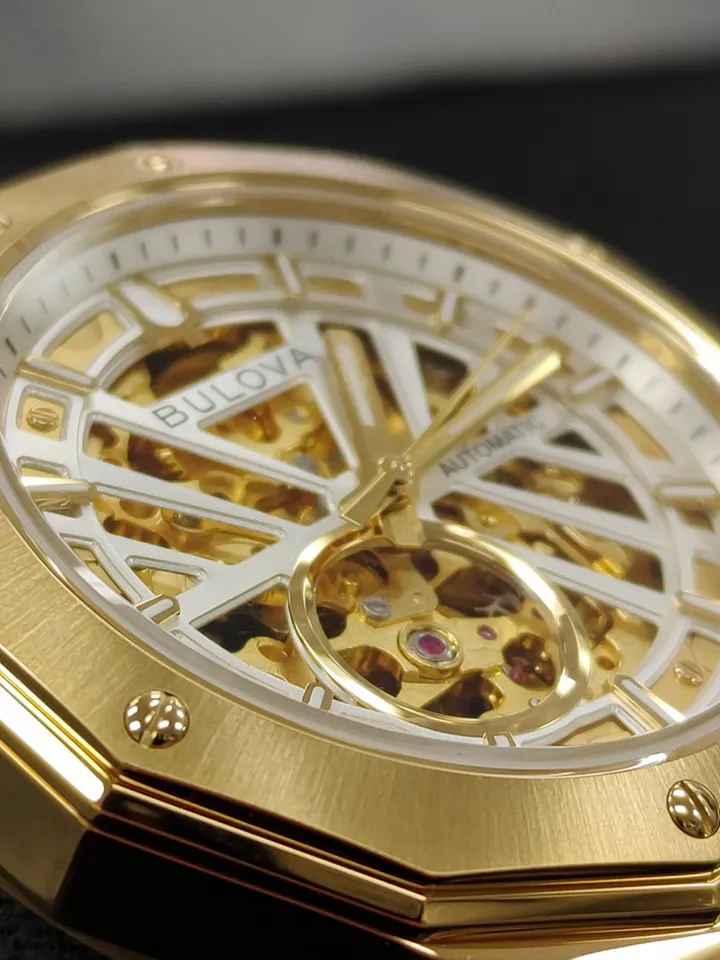 Brand new Bulova Maquina gold-tone automatic skeleton watch with black leather strap and original box