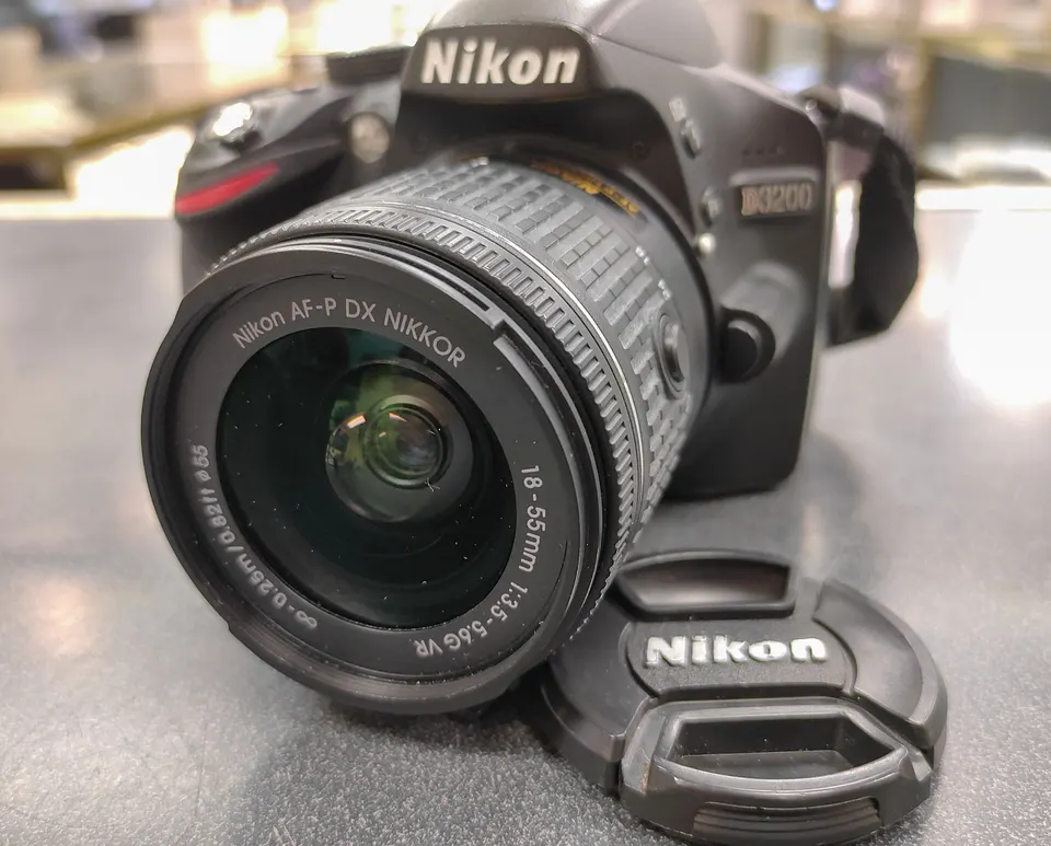 Nikon D3200 DSLR camera body with Nikon battery, charger, 32GB SD card and neck strap