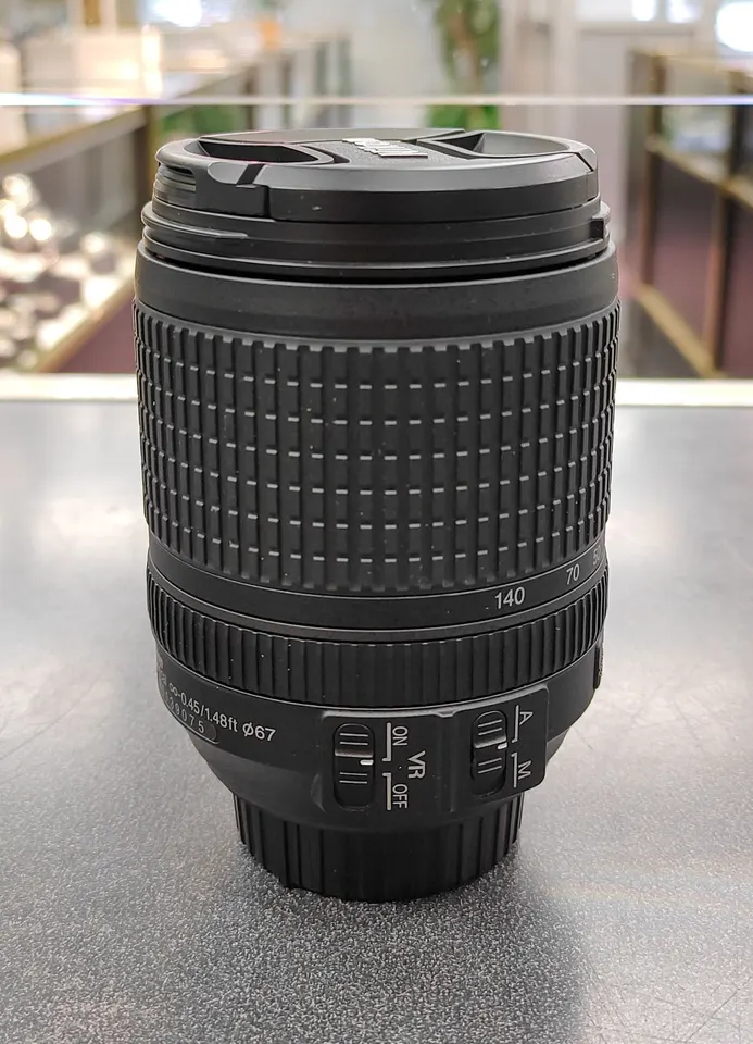 Nikon AF-S DX 18-140mm f/3.5-5.6G ED VR zoom lens with front and rear caps