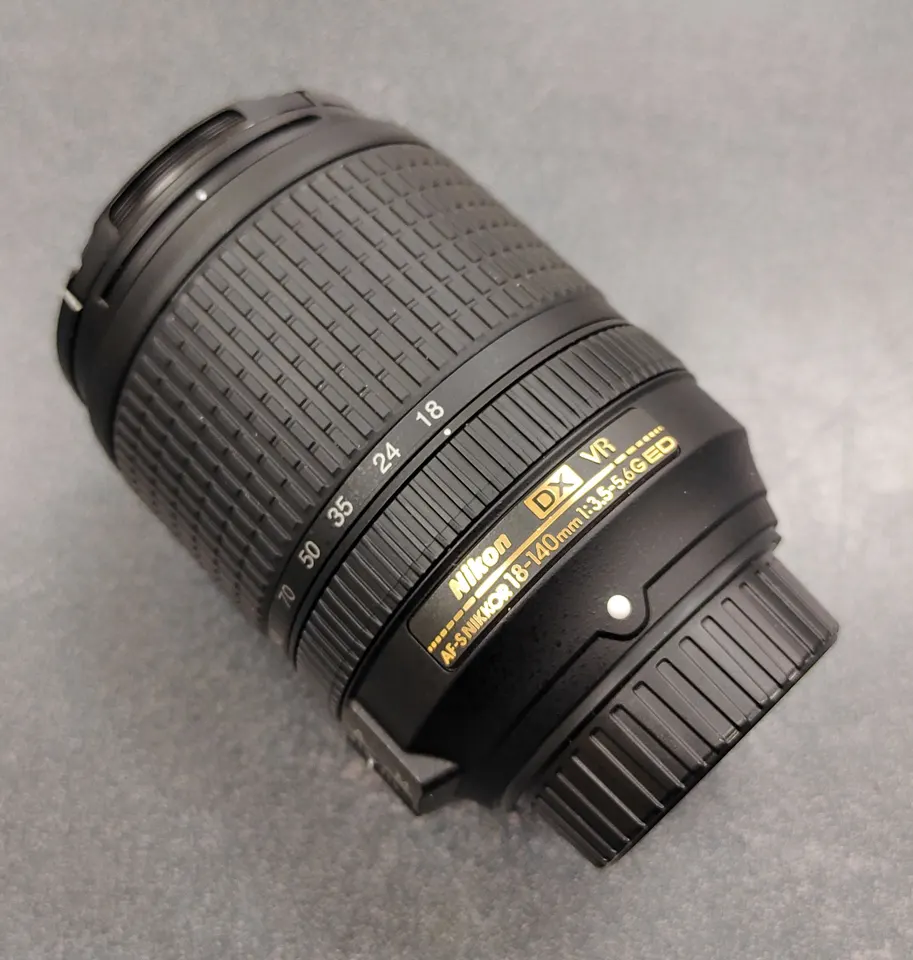 Nikon AF-S DX 18-140mm f/3.5-5.6G ED VR zoom lens with front and rear caps
