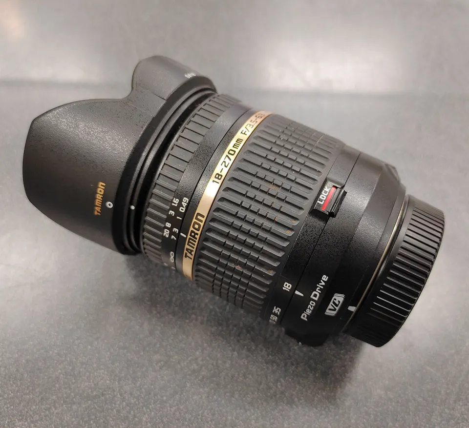 Tamron 18-270mm f/3.5-6.3 Di II VC PZD Nikon F-mount lens with hood and caps