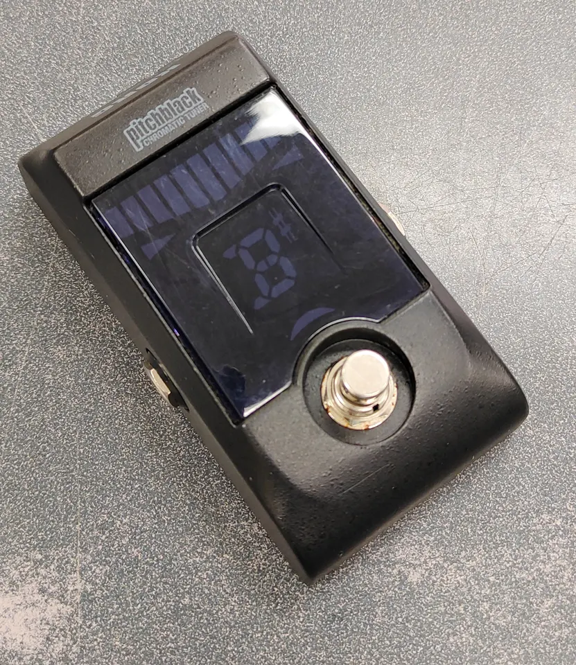 Korg Pitchblack PB-01 chromatic tuner pedal with visible used wear and scratched display lens