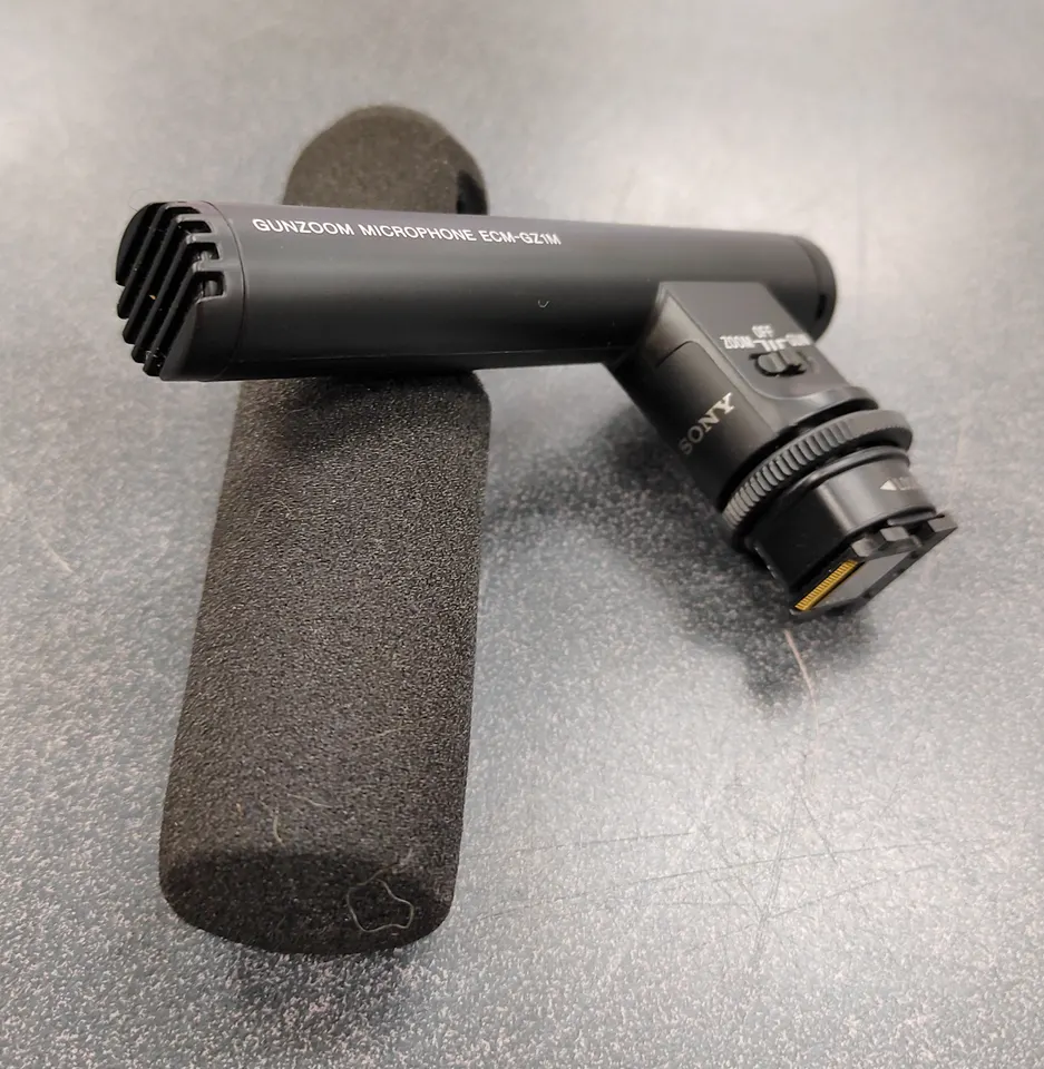 Sony ECM-GZ1M gun zoom microphone with foam windscreen attached, shown in excellent condition for Sony Multi Interface Shoe