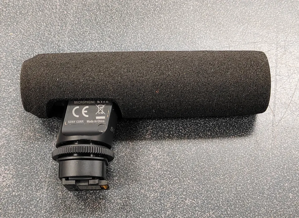 Sony ECM-GZ1M gun zoom microphone with foam windscreen attached, shown in excellent condition for Sony Multi Interface Shoe
