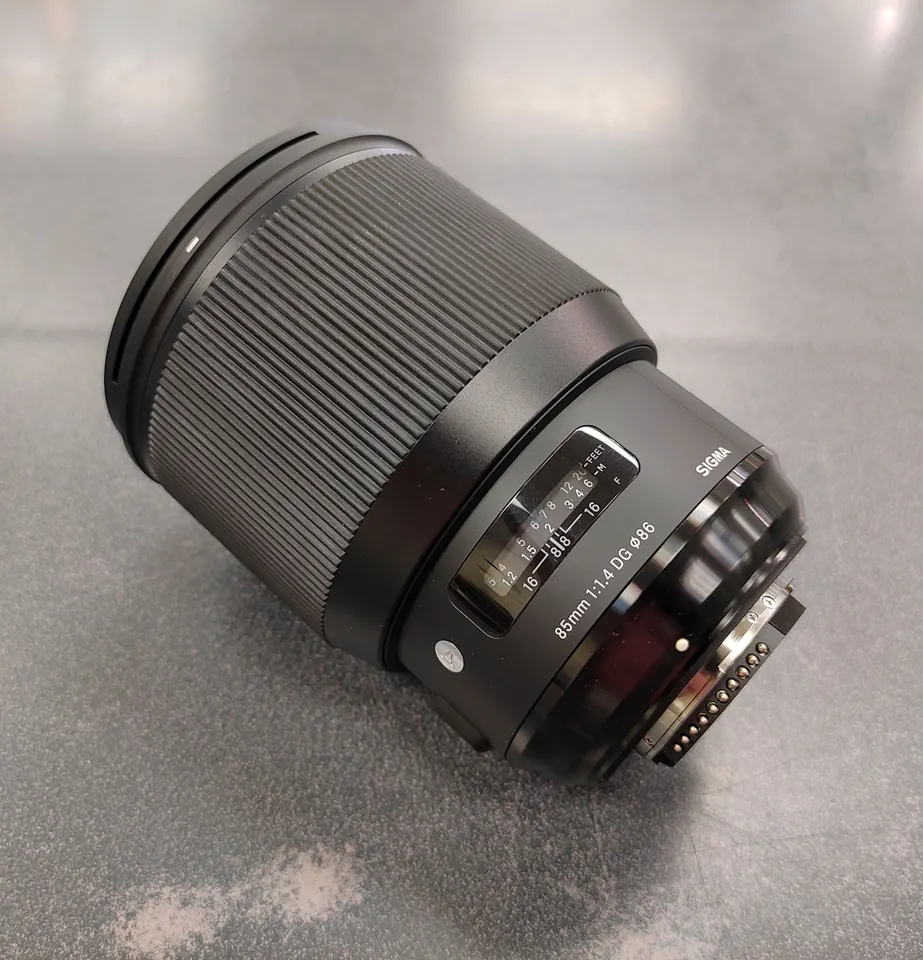 Sigma 85mm f/1.4 DG HSM Art Nikon F-mount lens shown from multiple angles with clean front and rear glass, Nikon mount contac
