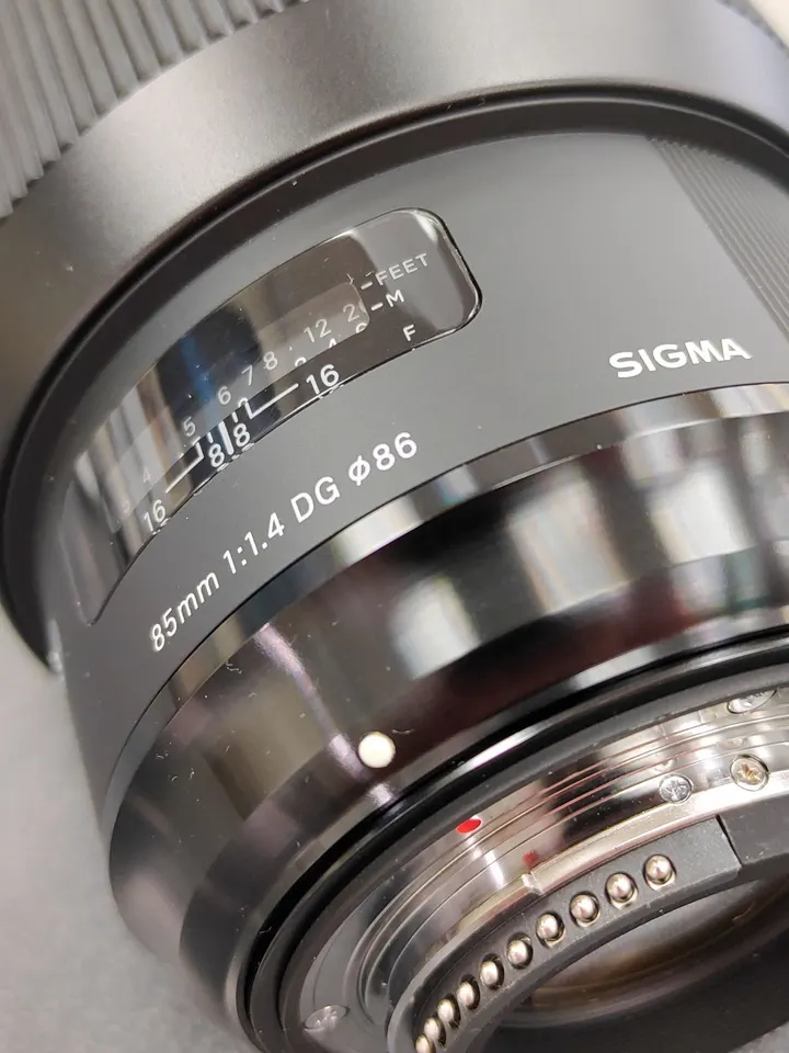 Sigma 85mm f/1.4 DG HSM Art Nikon F-mount lens shown from multiple angles with clean front and rear glass, Nikon mount contac