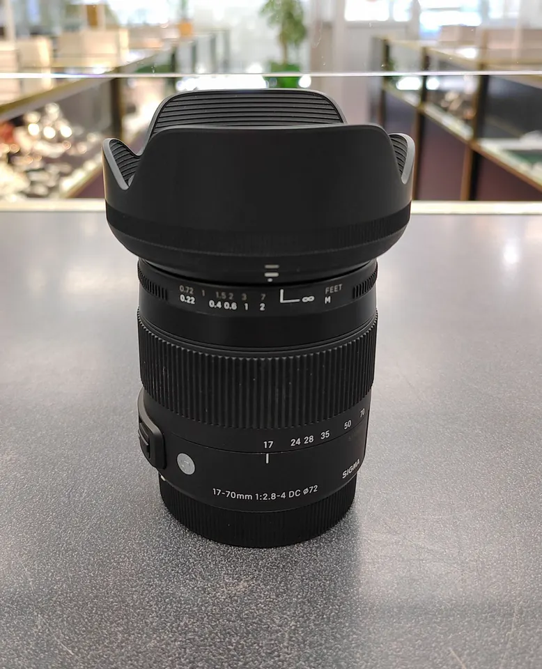 Sigma 17–70mm f/2.8–4 Canon APS-C zoom lens with petal hood and front and rear caps