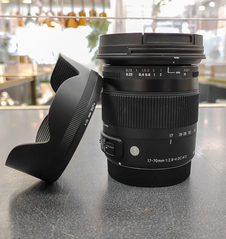 Sigma 17–70mm f/2.8–4 Canon APS-C zoom lens with petal hood and front and rear caps