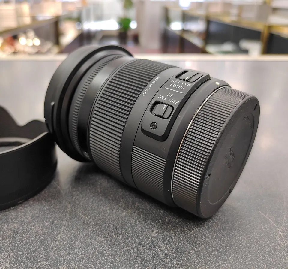 Sigma 17–70mm f/2.8–4 Canon APS-C zoom lens with petal hood and front and rear caps