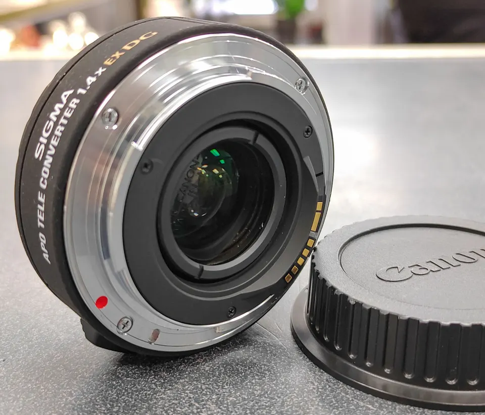 Sigma APO 1.4x EX DG Canon EF teleconverter with front and rear protective caps