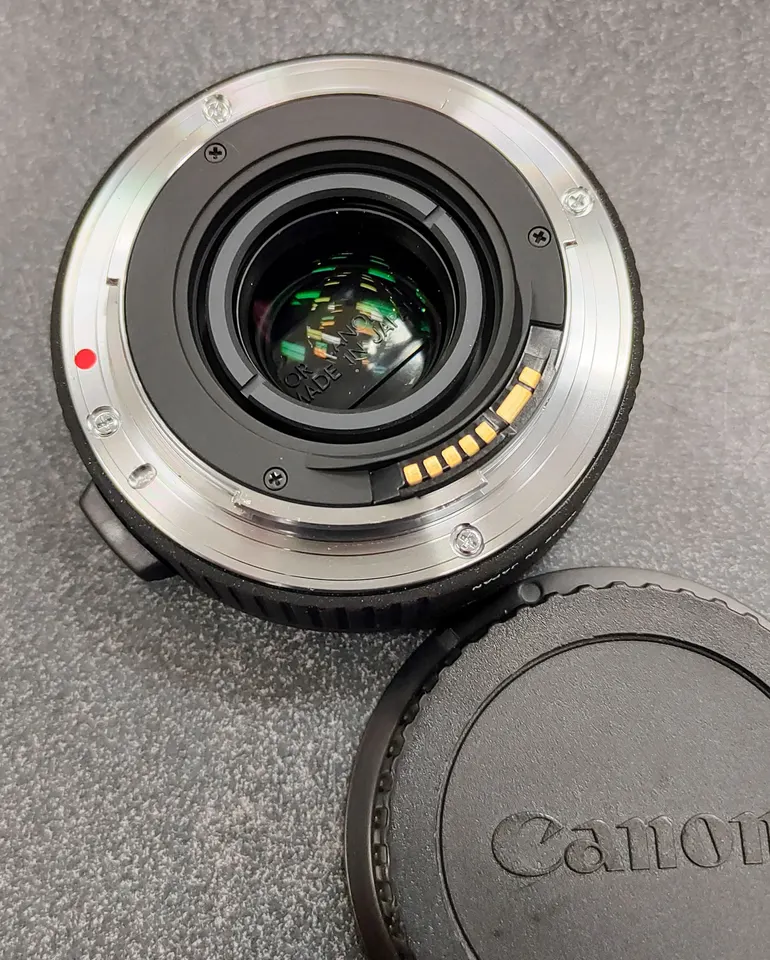 Sigma APO 1.4x EX DG Canon EF teleconverter with front and rear protective caps