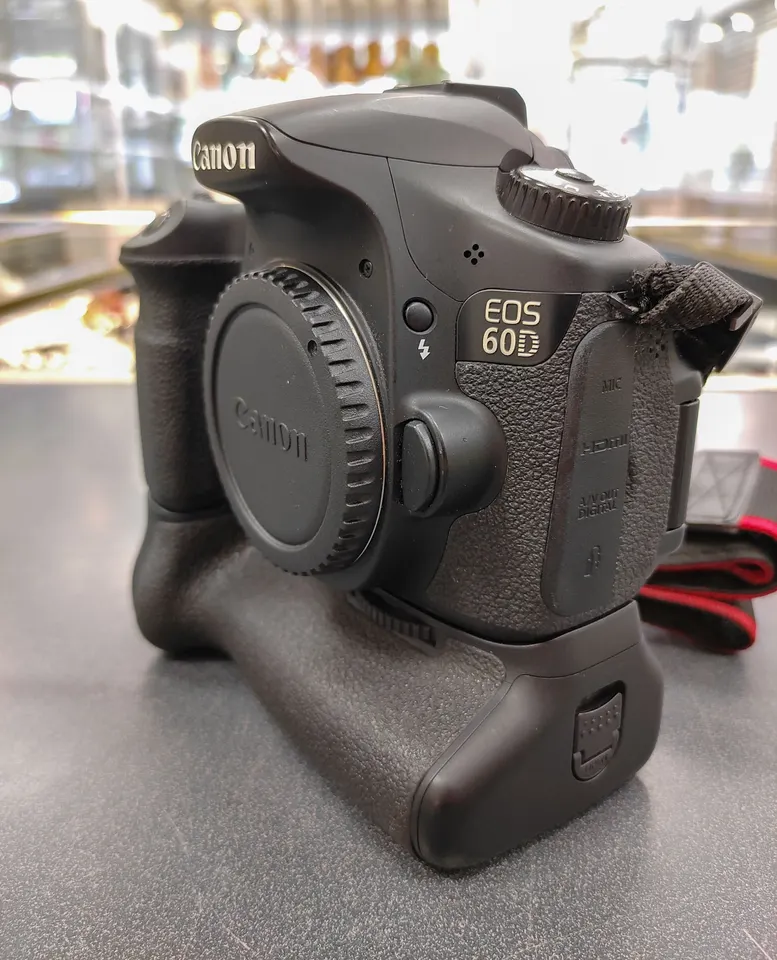 Canon EOS 60D DSLR camera body with genuine Canon BG-E9 battery grip, body cap, strap, battery, travel charger, 16GB SD card