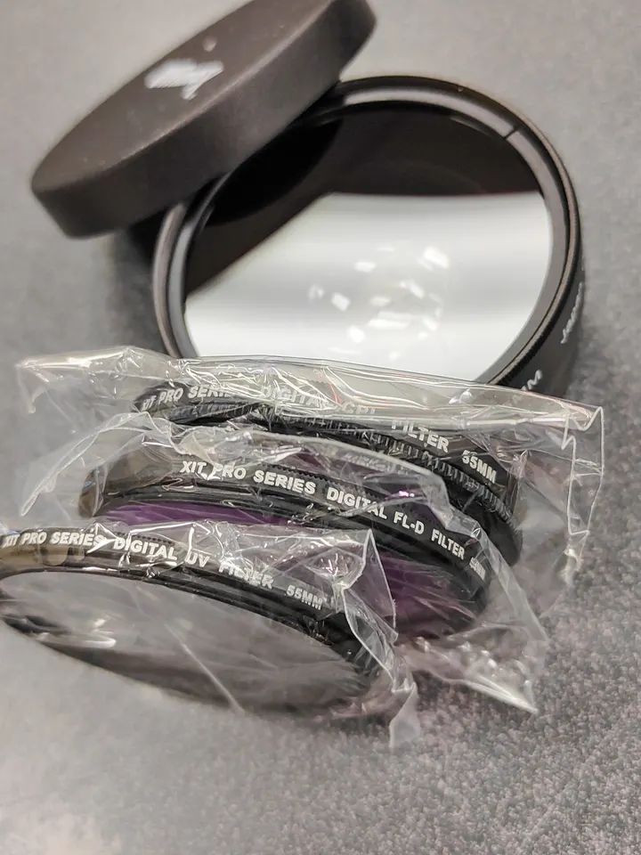 Ultimaxx / XIT 55mm camera accessory bundle with wide-angle, telephoto, filters, caps, and pouches