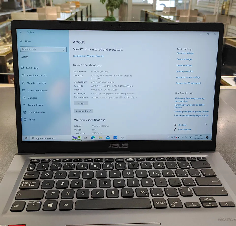 ASUS VivoBook M415DA / X415DAP 14-inch laptop in gray with Ryzen 3 sticker, Windows 10 screen on, and original ASUS charger