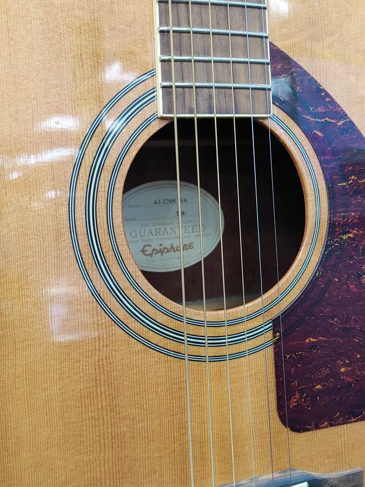 Epiphone AJ-220S NA acoustic guitar in natural finish with tortoise-style pickguard, chrome tuners, light cosmetic wear