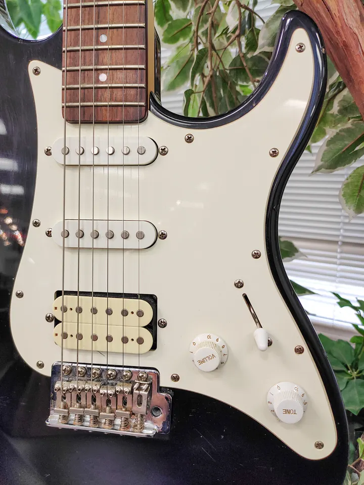 Yamaha EG112 black HSS electric guitar with cream pickguard, maple neck, dark fingerboard, chrome hardware, tremolo bridge