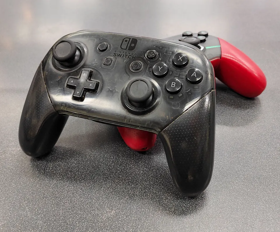 Nintendo Switch Xenoblade Chronicles 2 red and turquoise Pro Controller & a standard translucent black Switch Pro Controller