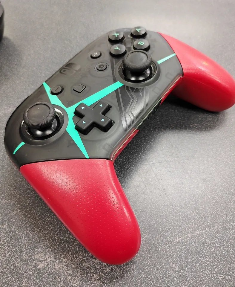 Nintendo Switch Xenoblade Chronicles 2 red and turquoise Pro Controller & a standard translucent black Switch Pro Controller