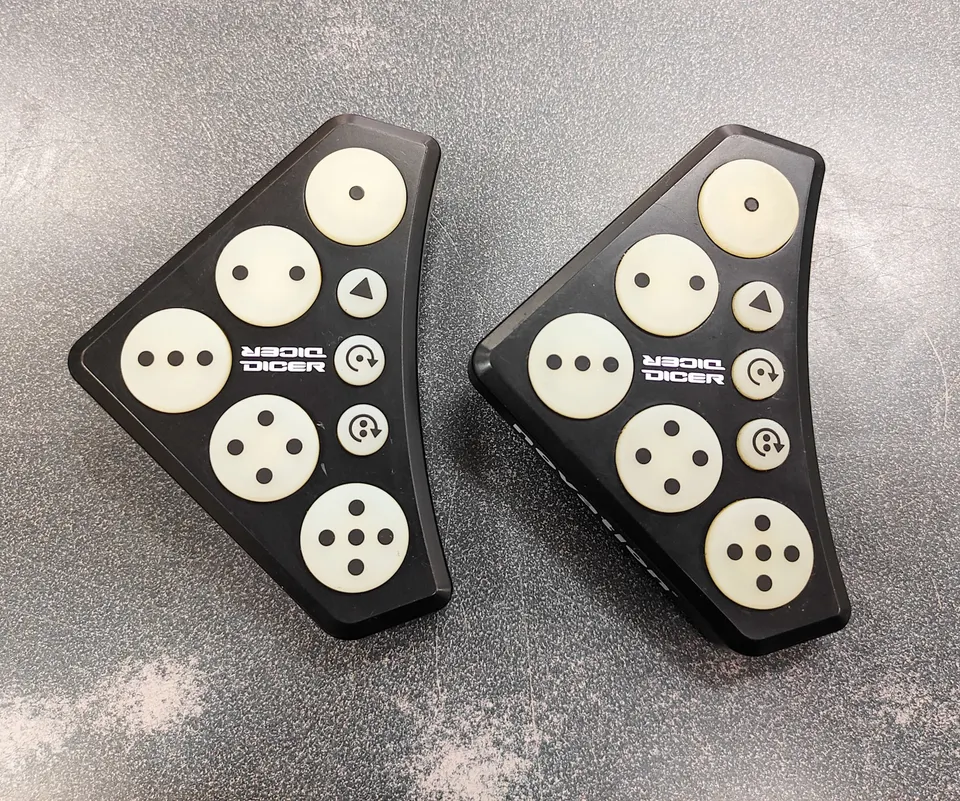 Pair of Novation Dicer USB MIDI DJ controllers in good used condition with visible age-related pad discolouration
