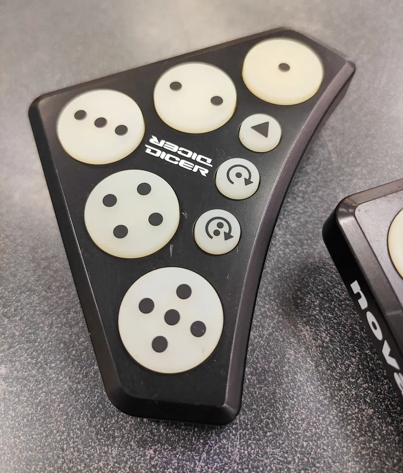 Pair of Novation Dicer USB MIDI DJ controllers in good used condition with visible age-related pad discolouration