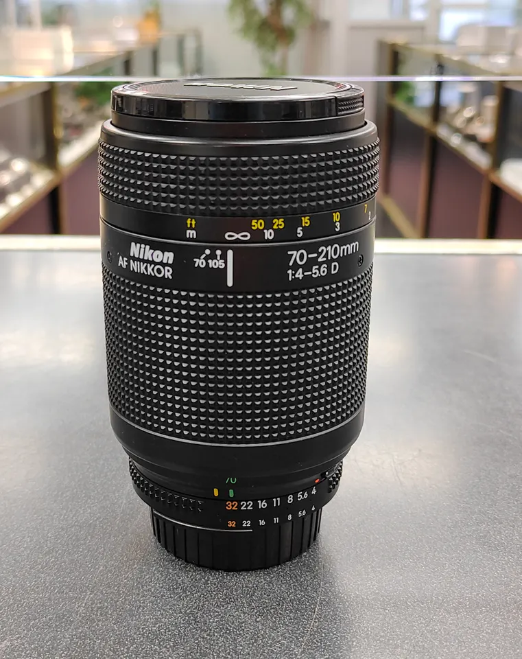 Nikon AF Nikkor 70–210mm f/4–5.6D zoom lens with front and rear caps