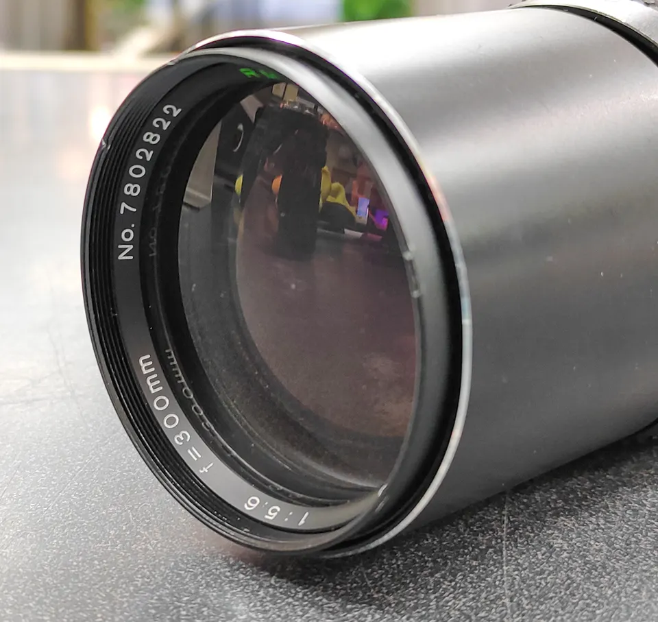 RMC Tokina Tele-Auto 300mm f/5.6 Minolta MD-mount lens shown from front and rear